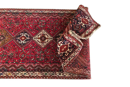 Red runner with folded edges and traditional patterns