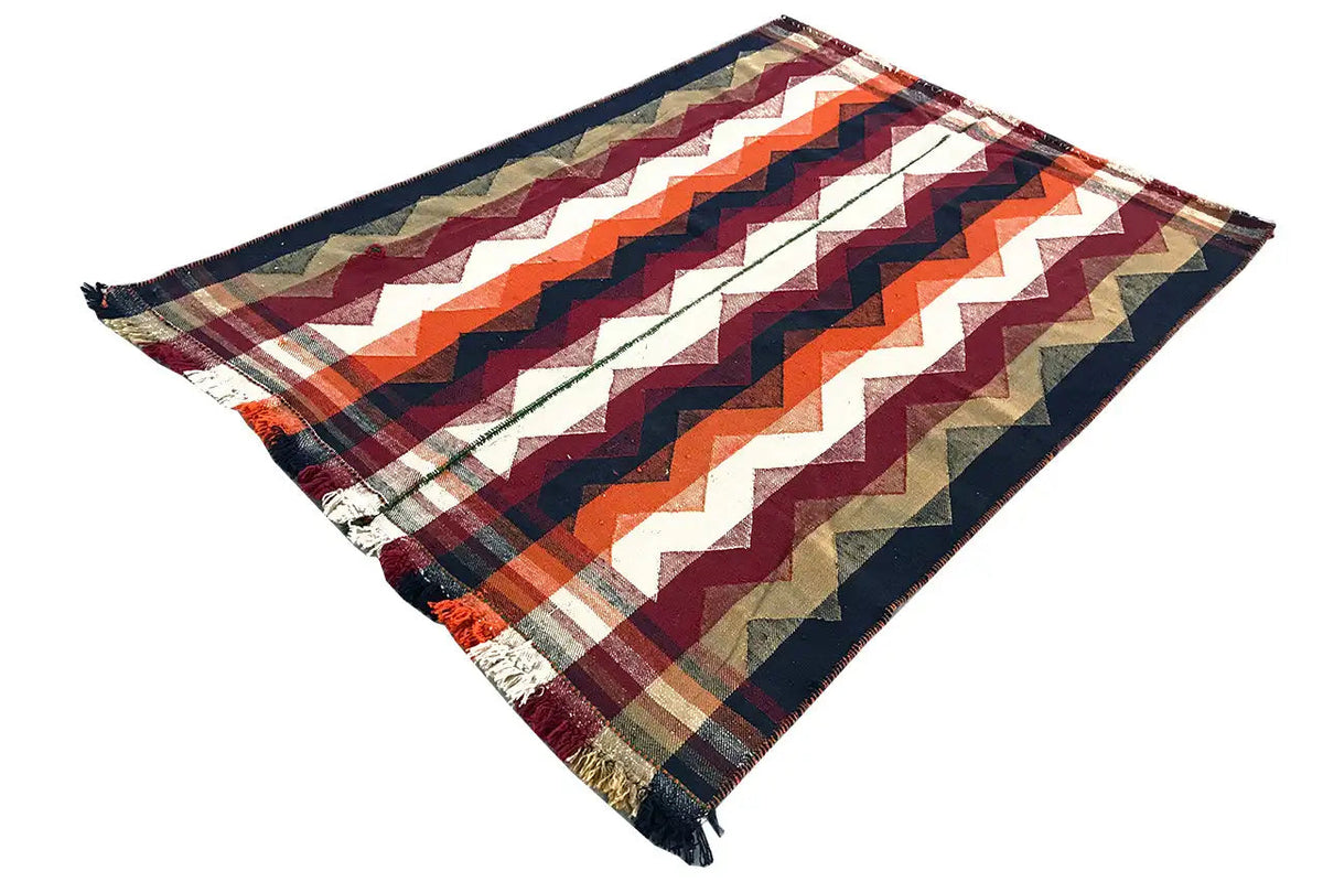 Rectangular jajim rug with a zigzag pattern in dark blue, orange, burgundy and cream, fringes