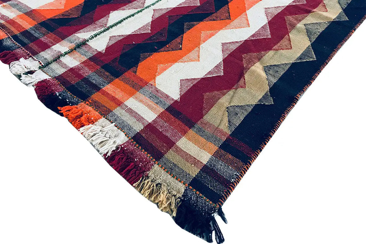 Jajim rug with zigzag stripes in blue, orange, and burgundy, rounded corner with fringe
