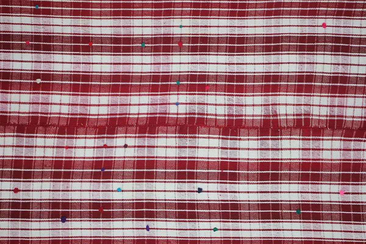 Close-up of a jajim rug: fine red and white lines with small dots