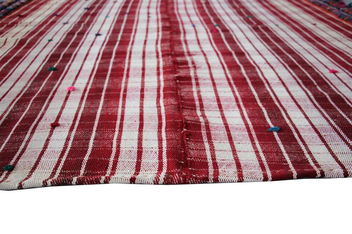 Close-up of a jajim rug: red and cream-colored stripes, continuous lines