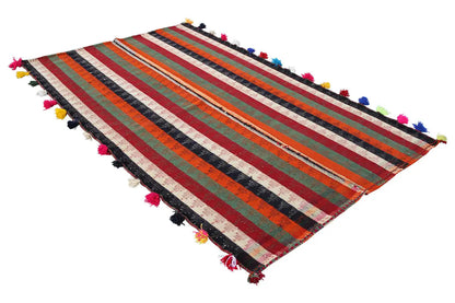 Jajim rug in three-quarter view, multicolored stripes with colorful tassels.
