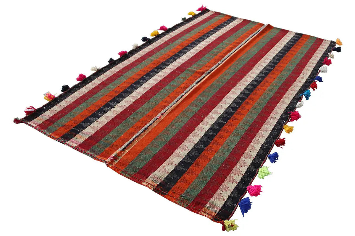 Jajim rug laid at an angle, striped pattern with colorful tassels along the edges.