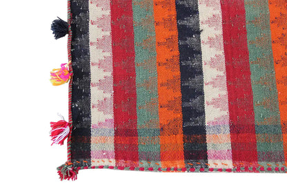 Jajim rug corner with colorful fringes and multicolored vertical stripes.