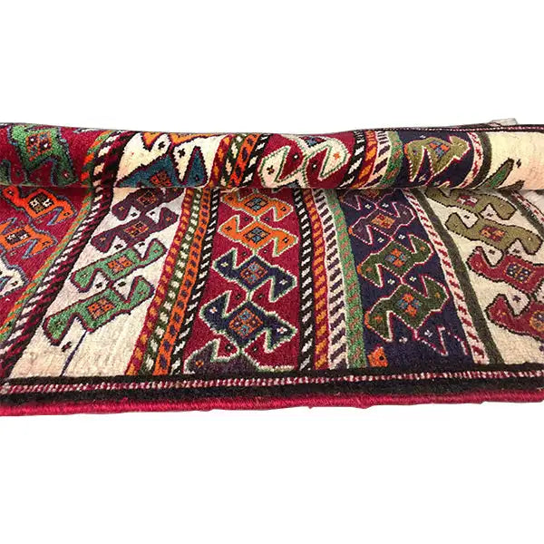 Qashqai rug by Poschti: side view with bold patterns and visible selvedge