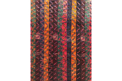 Close-up of a Shiraz Qashqai oriental rug: colorful zigzag stripes in dark red and orange