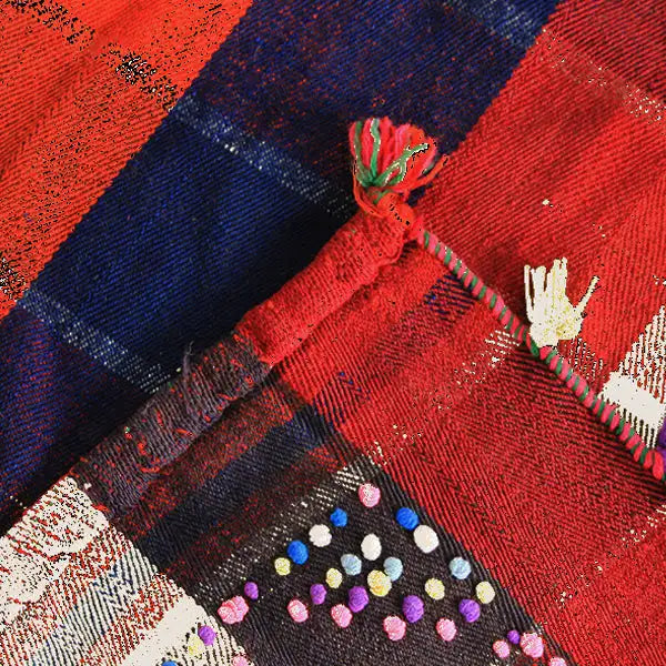 Jajim fabric detail in red and dark blue with patterned stripes and colored dots