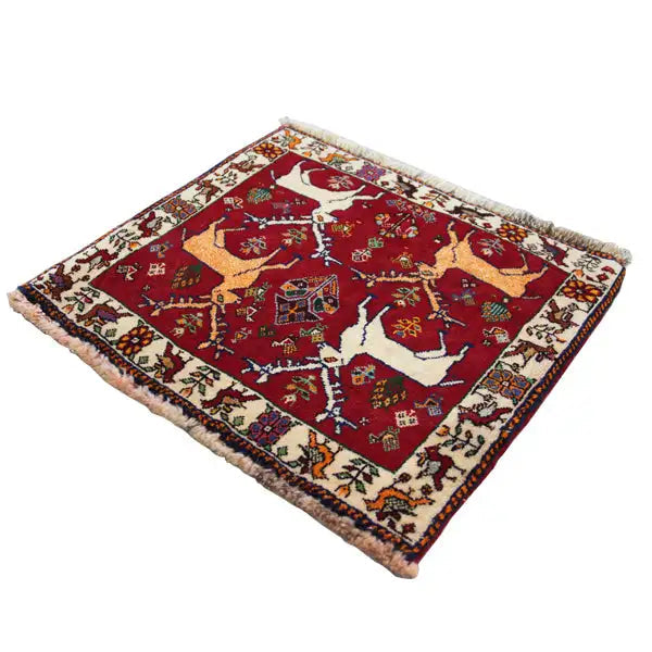 Qashqai rug 61x54 cm: red background with animal motifs, fringes along the edges