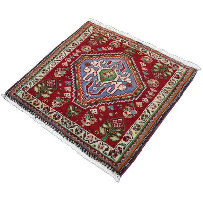 Carpet 63x60 cm with a red base and multicolored ornament, trimmed with fringes