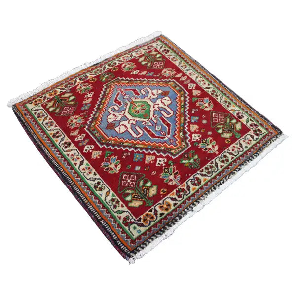 Rug 63x60 cm with a red background, central blue-green medallion, and fringed border