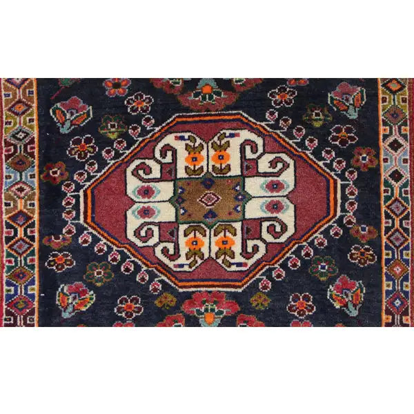 Poschti Qashqai rug detail: round central medallion with colorful symbols