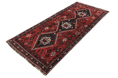 Red runner with dark blue accents, geometric ornament, and decorative fringe