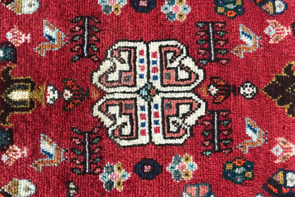 Close-up of the central motif: red carpet with a symmetrical medallion