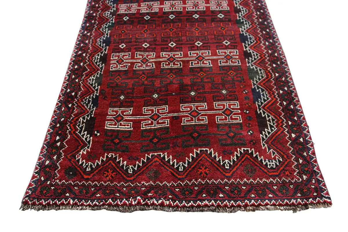 Qashqai runner viewed from above: red patterned field, darkly framed, with a border along the edges