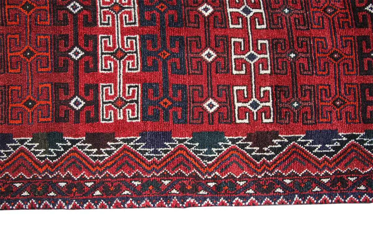 Qashqai runner detail at the hem: red and black geometric patterns with decorative trim