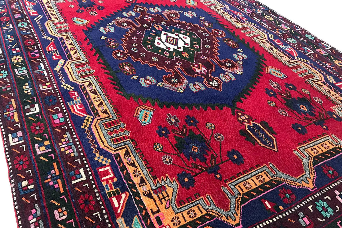 Sirjan rug: close-up of the center with colorful ornaments and a blue field