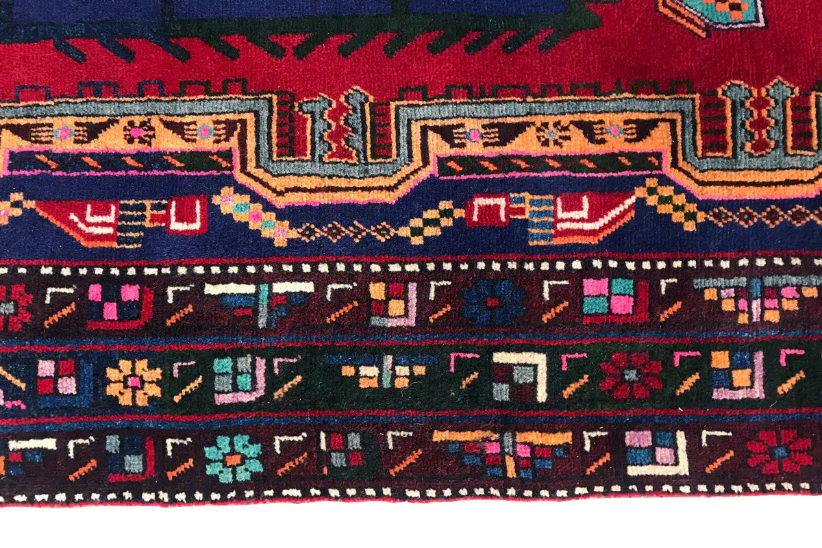 Sirjan rug: close-up of the border with geometric rows in red, blue, and yellow