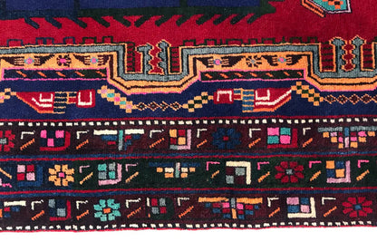 Sirjan rug: close-up of the border with geometric rows in red, blue, and yellow