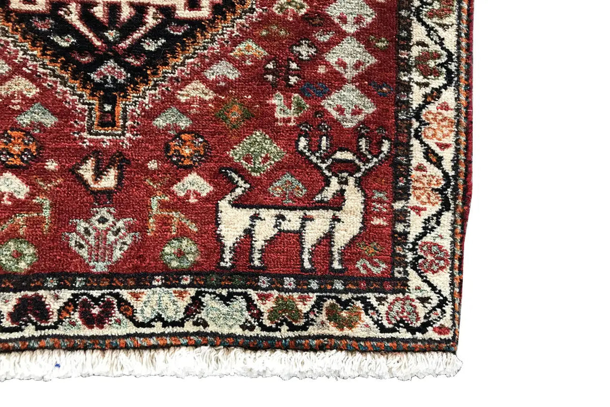 Close-up: red carpet with border ornaments and a decorative corner area