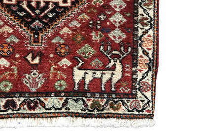 Close-up: red carpet with border ornaments and a decorative corner area