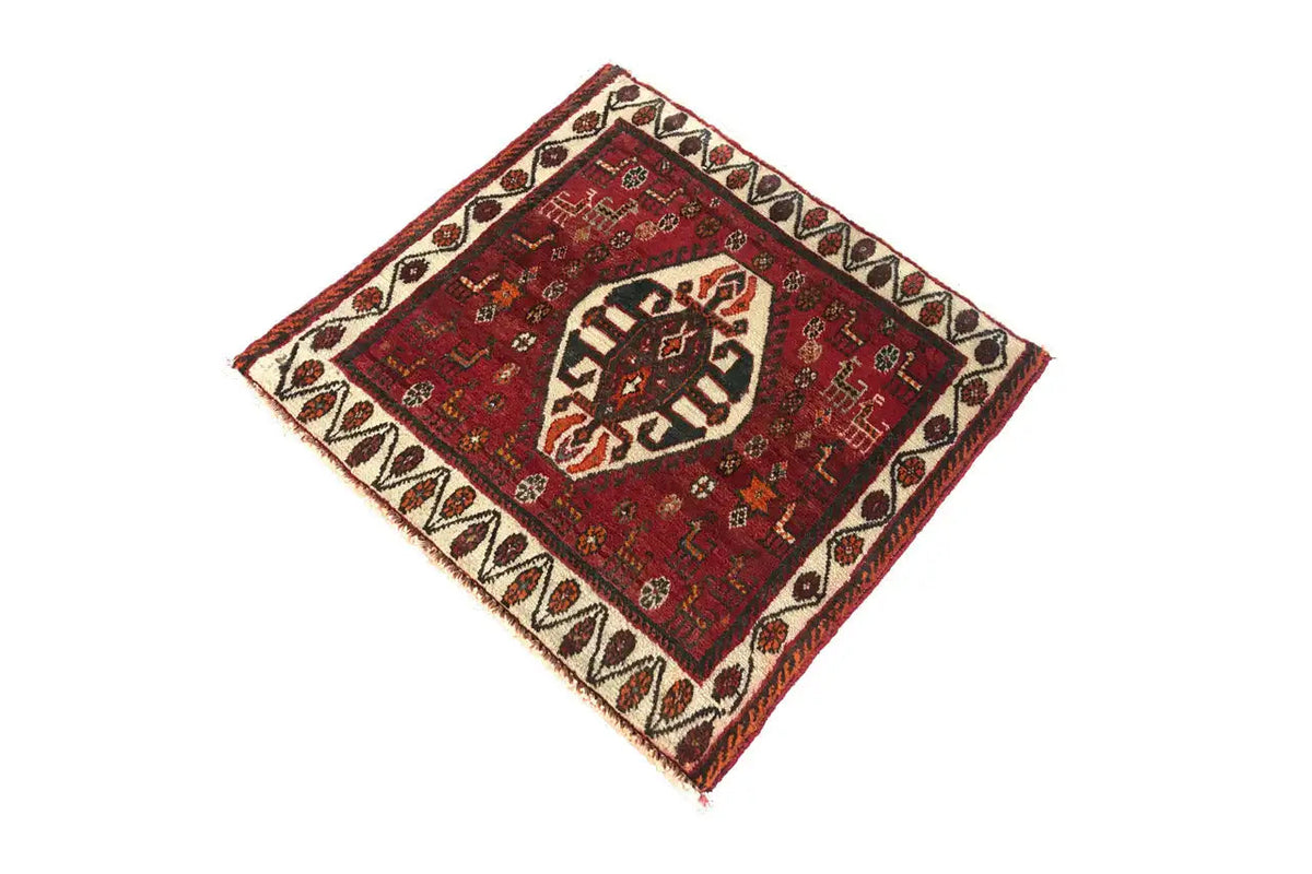 Square rug with a red central field, white border, and fringe
