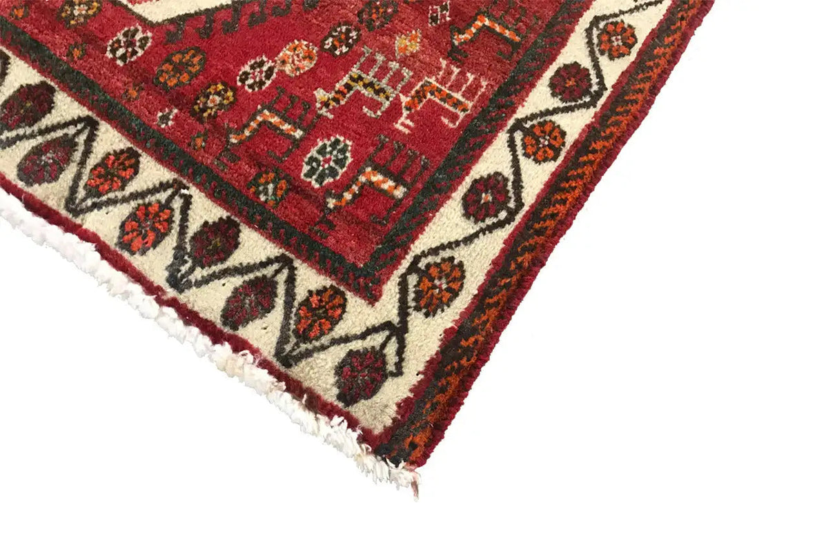 Close-up detail of a rug with fringes and a multicolored geometric pattern