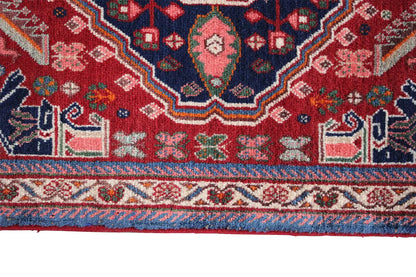 Oriental carpet border detail, red area with colorful symbols and fringes