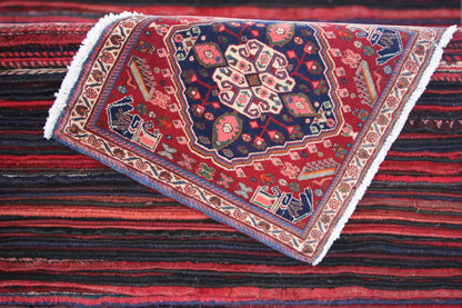 Oriental rug viewed diagonally, red field with medallion pattern, white fringes
