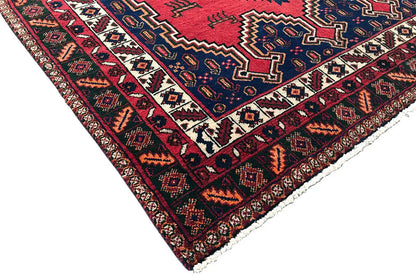 Oriental rug corner with a red border, blue background, and white ornamental stripes.