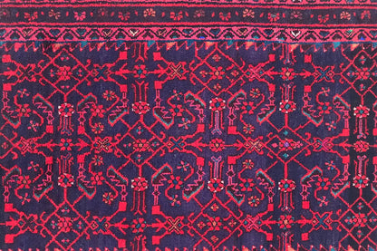 Close-up of a Hamadan runner: burgundy ornamental design on a dark blue background