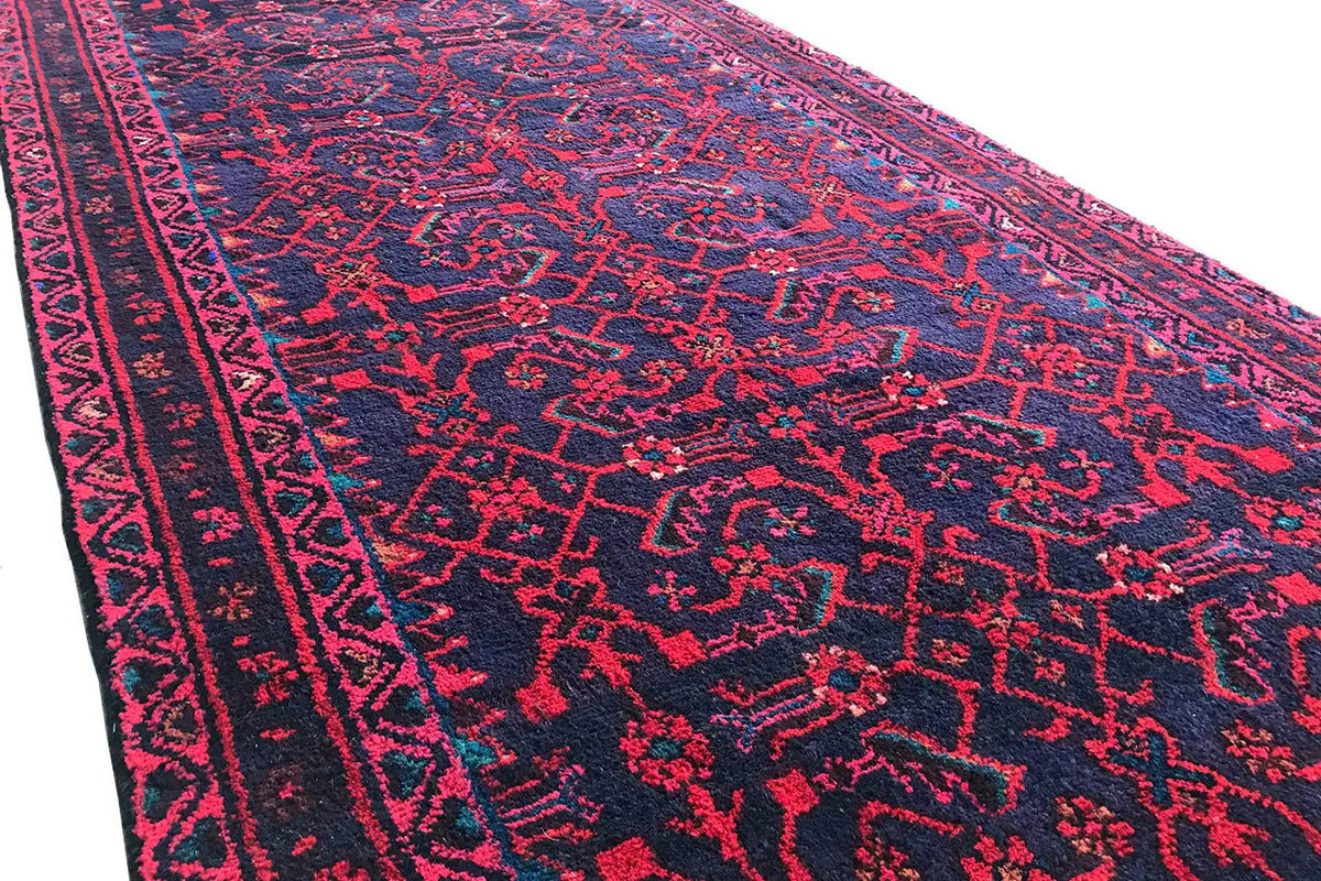 Hamadan runner close-up: dense burgundy ornamental pattern on dark blue