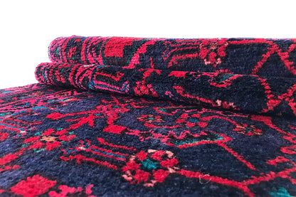 Hamadan runner rolled up: burgundy ornaments on a dark blue background