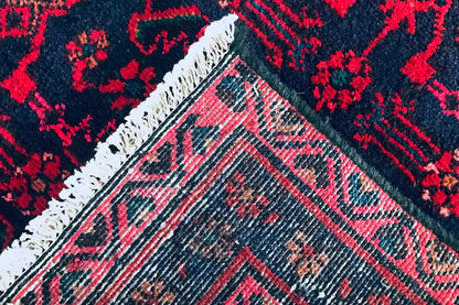 Hamadan runner detail: burgundy vines and geometric border with fringe