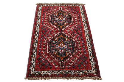 Oriental rug with a red background and geometric pattern, fringes along the edges