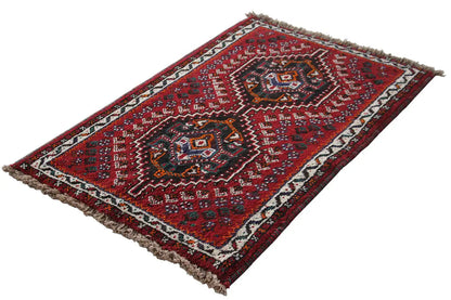 Oriental rug with a red border pattern and fringes, rectangular, photographed diagonally