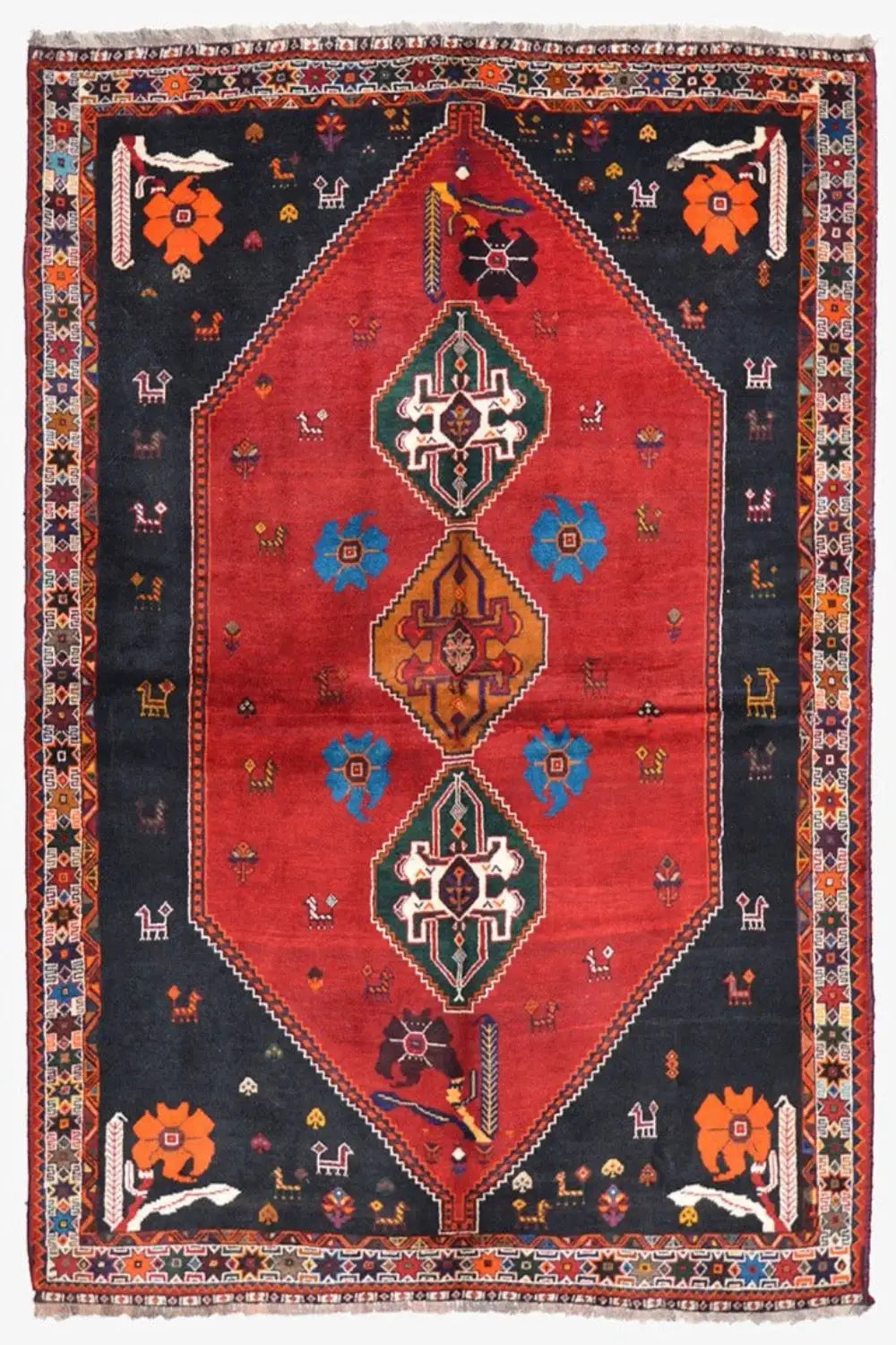 Oriental rug with a red central medallion, dark blue background, and colorful ornamental insets