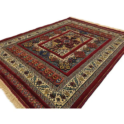 Rug with a diagonal border, cream-colored background, red accents, and fringe