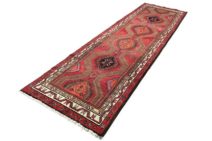 Red Hamadan runner with a geometric pattern, contrasting borders, and fringed ends