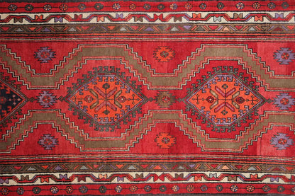 Close-up of the Hamadan runner: red ground with star-shaped medallions and repeating patterns