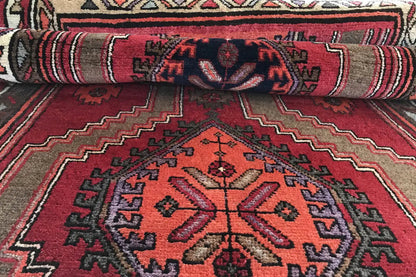Hamadan runner detail with rolled edge: central medallion, surrounding borders and pattern