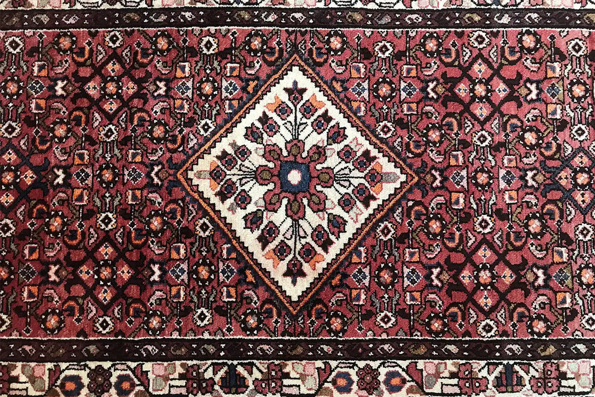 Hamadan runner detail: central diamond with decorative flowers and intricate ornamentation