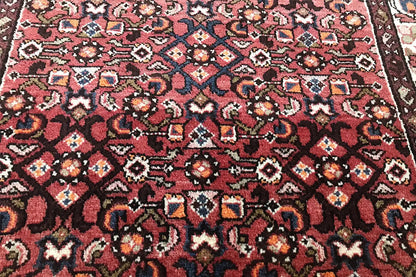 Hamadan runner close-up: dense red multicolored tile pattern