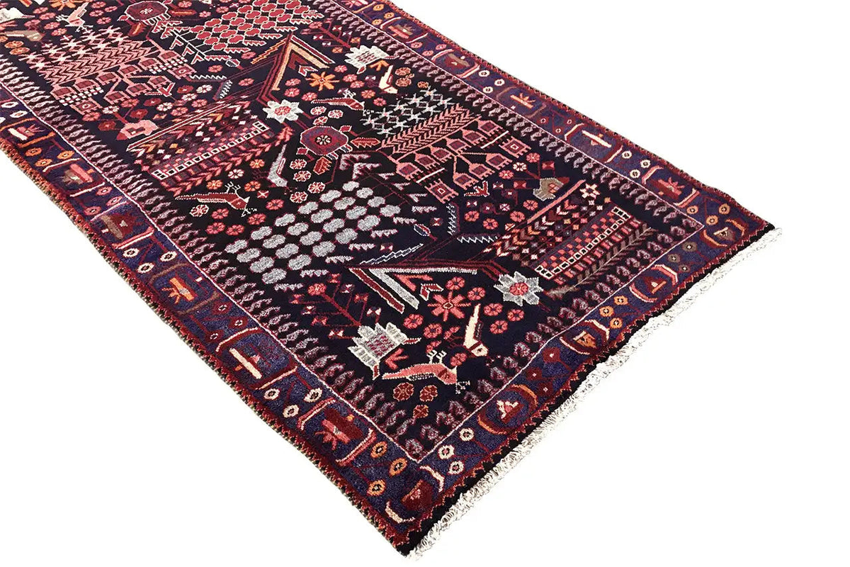 Oriental runner rug with a delicate medallion pattern, dark blue border, and red detailed trim