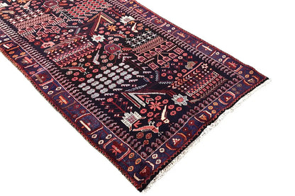 Oriental runner rug with a delicate medallion pattern, dark blue border, and red detailed trim