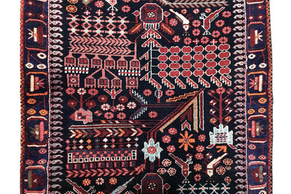 Close-up of a runner rug: dark base pattern with red floral and vine ornamentation