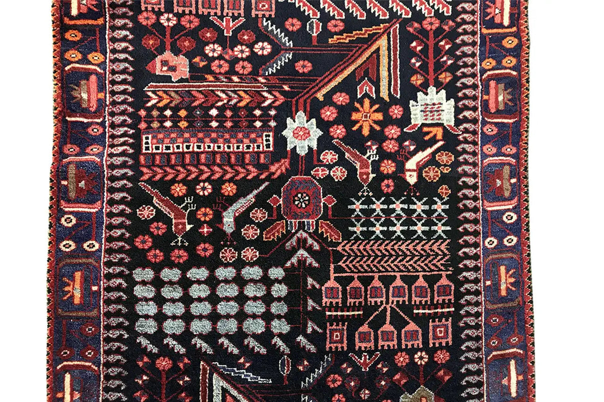 Close-up of a runner rug with contrasting geometric lines and red floral elements