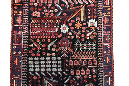 Close-up of a runner rug with contrasting geometric lines and red floral elements