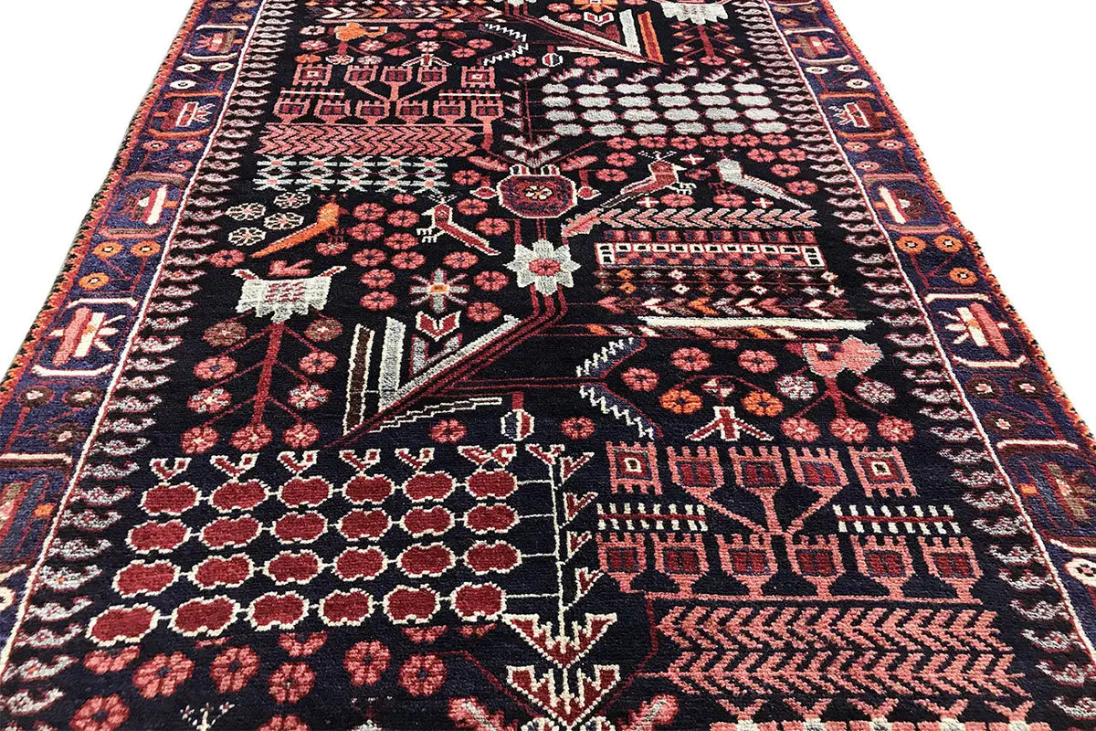 Detailed runner rug with a dark patterned field, red ornamental border, and white accents