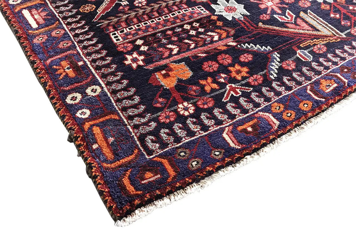 Corner view of a runner rug with a multicolored rug pattern and visible edge fringe