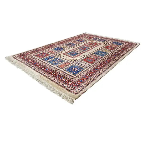 Oriental rug with a classic patchwork pattern, red-blue-yellow, with fringes along the edges